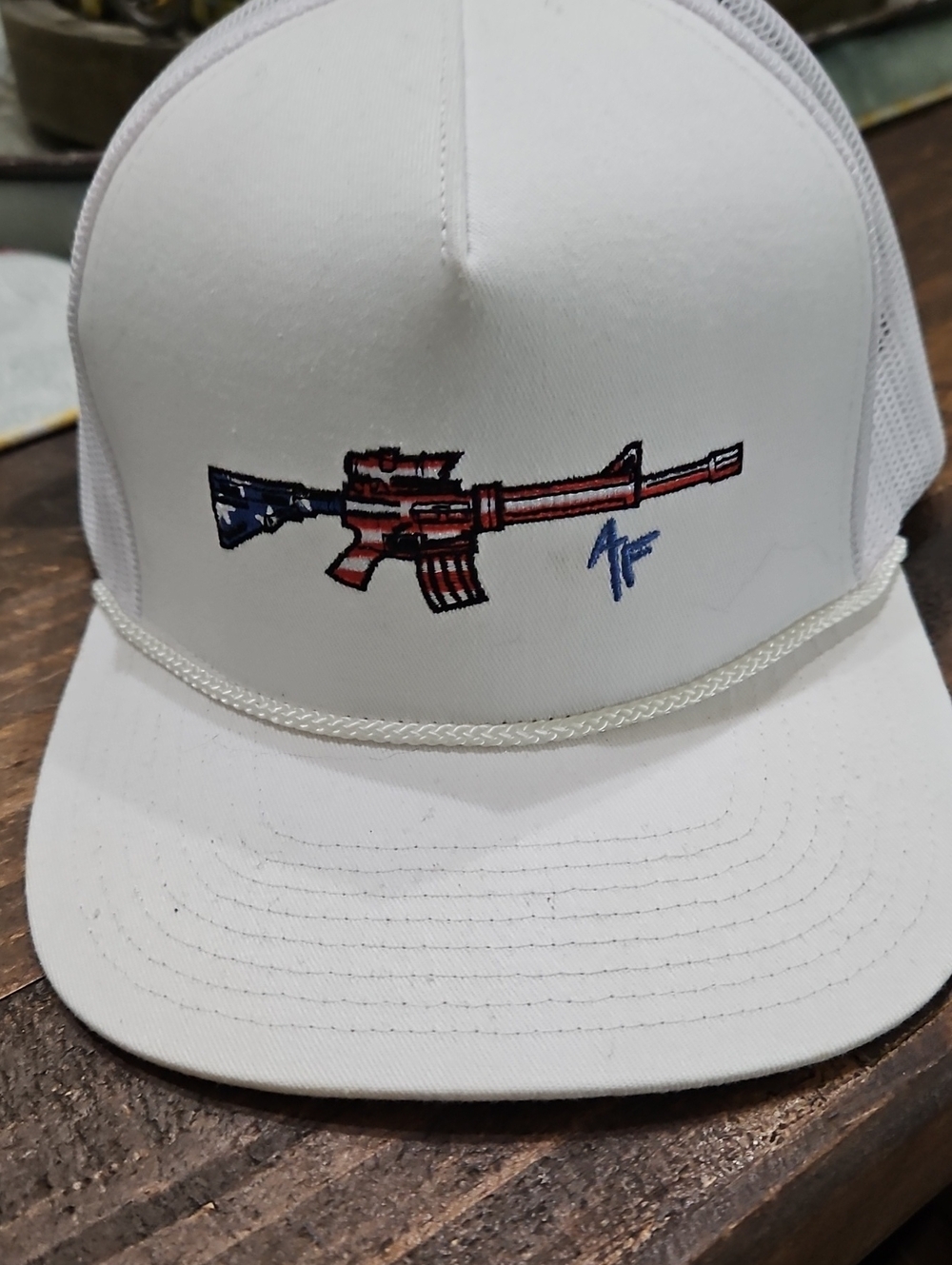 White Trucker Hat with Patriotic Rifle Embroidery